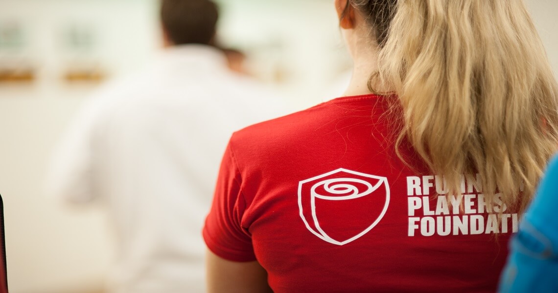 Women with blonde hair with IPF top on facing backwards